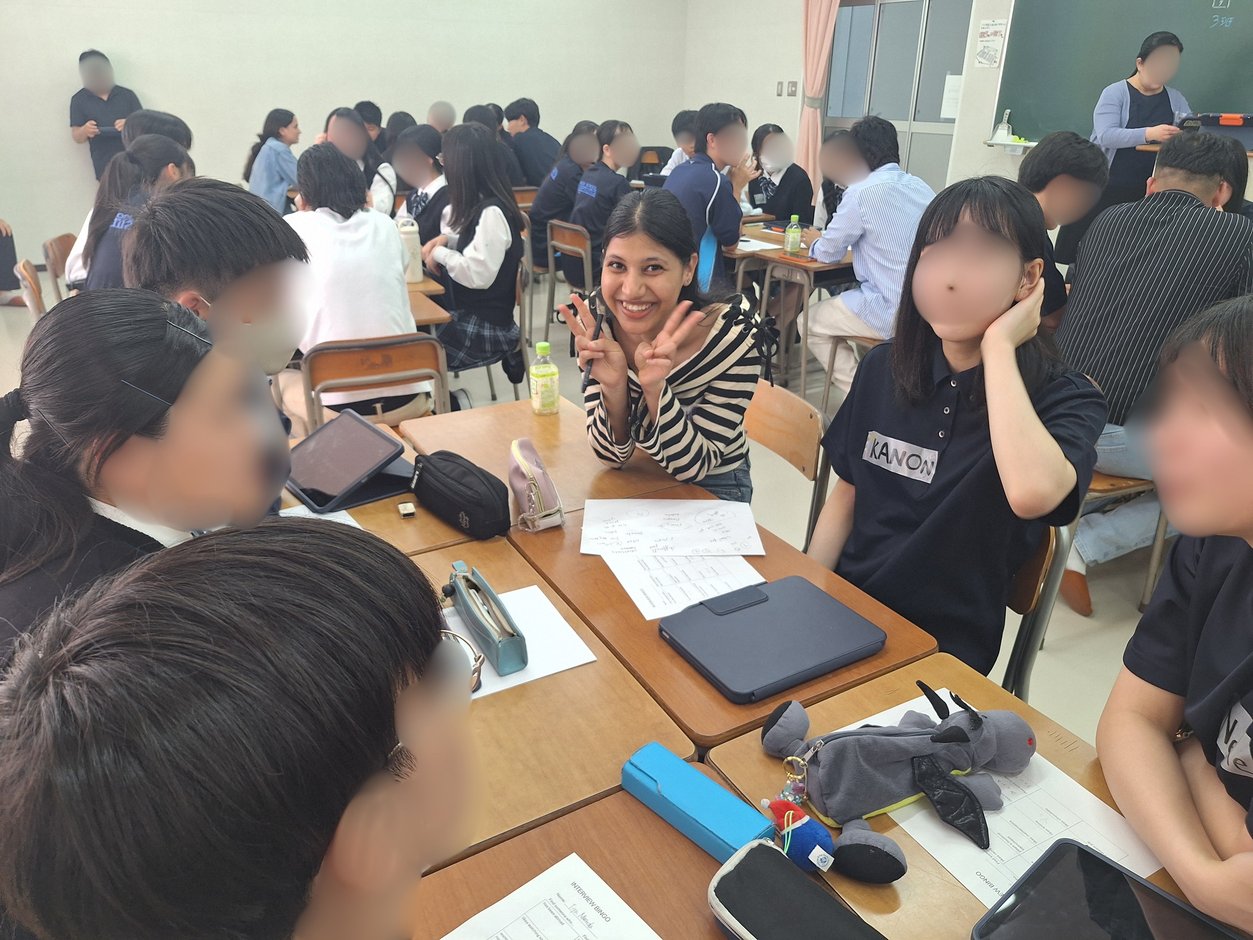 楽しい雰囲気の中、ピース!で写真を撮る学生